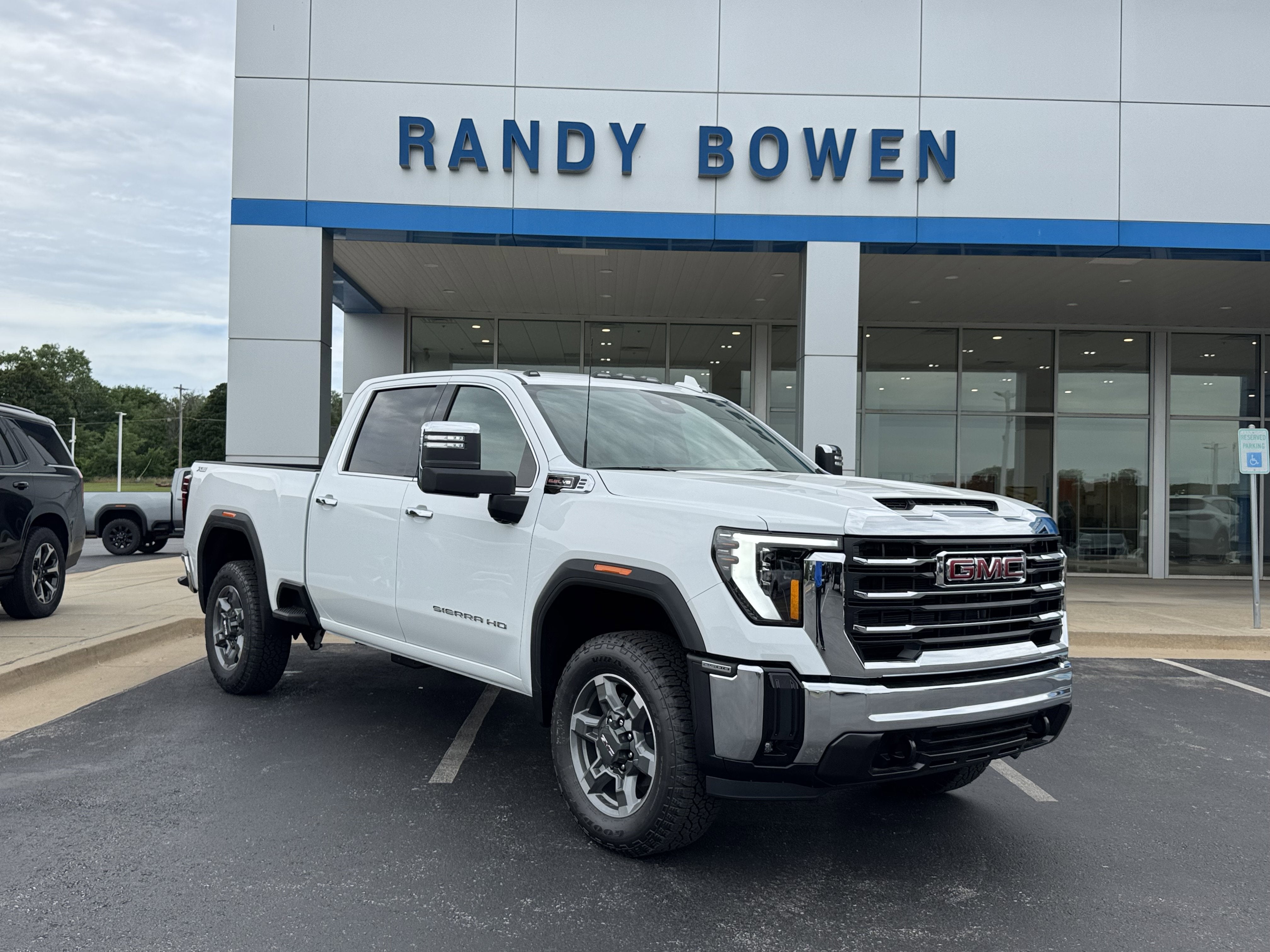2026 GMC Sierra 2500 HD SLT in Summit White — front three-quarter view
